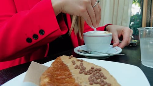 Putting Sugar Inside A Cappuccino Cup