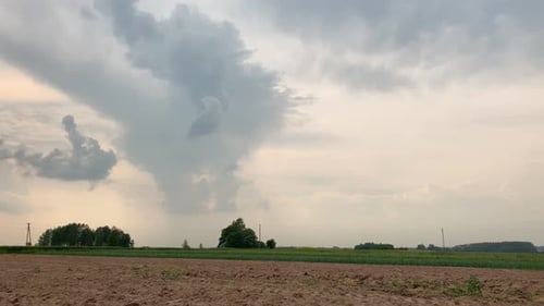 Beautiful, Stunning Clouds Over An Agricultural Field In Latvia - Timelapsed Tilt Up Shot
