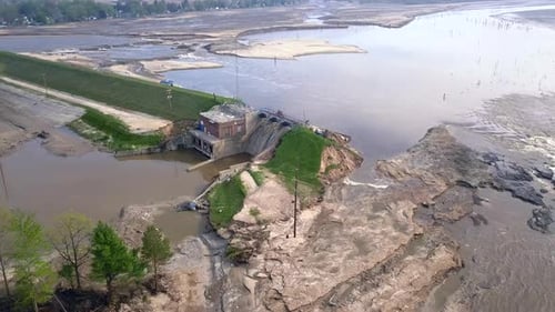 Aerial view of dam and draining Wixom Lake in Michigan during flood