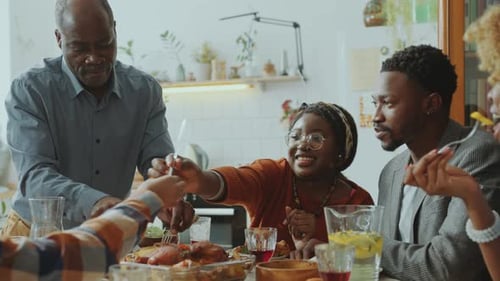 Family Gathering Around Table Enjoying a Meal Together
