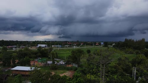 Drone footage of a dark storm above rural village out in the country.