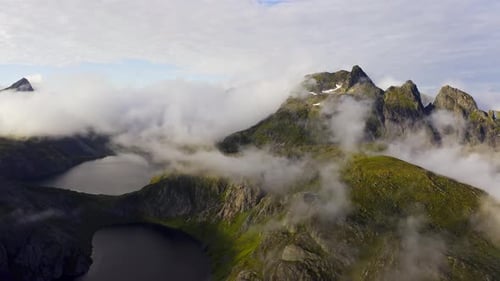 Aerial View of Sunset and Floating Clouds Above the Green Norway Lofoten Islands and Mountains