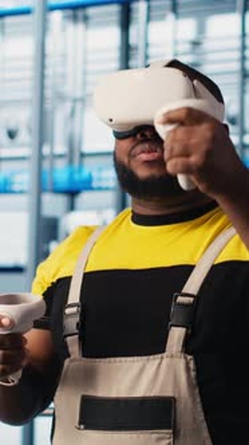 Vertical Video Smart Factory Engineer Using VR Headset to Oversee Operation of Robotic Arms