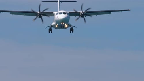 Turboprop Airplane Flying in Blue Sky Approaching for Landing