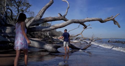 Aerial, Couple Walking Waves on Romantic Florida Beach Sunset Adventure
