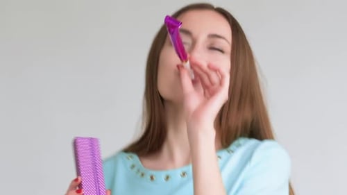 Woman Celebrates Birthday with Noisemaker and Gift