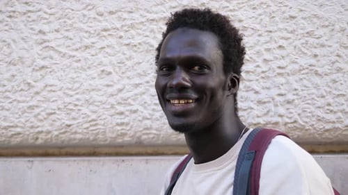 Young Man Smiling in an Urban Setting