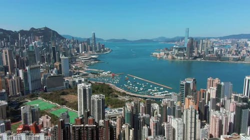 Aerial view of Hong Kong bay and skyscrapers on a beautiful day.