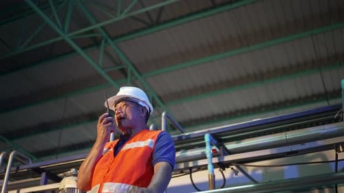 Employee is working at beverage factory.