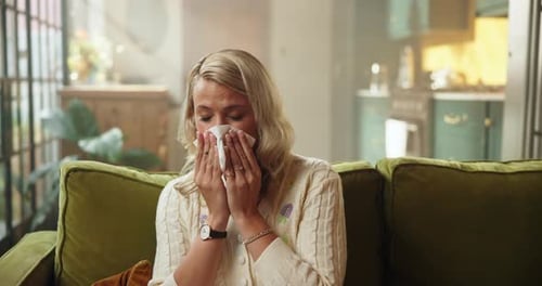 Woman Blowing Her Nose in Living Room