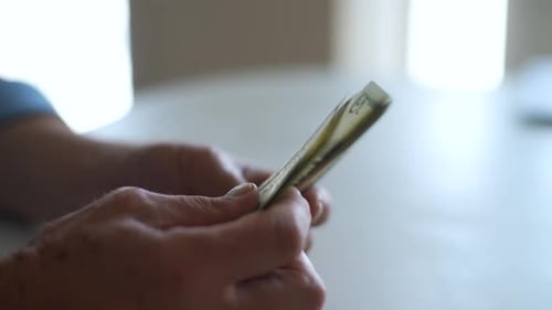 Closeup Side View Shot of Unrecognizable Mature Businessman Counting Dollar Bills Closeup of Senior