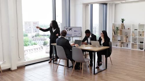 Colleagues Discussing Business Strategy During Office Meeting