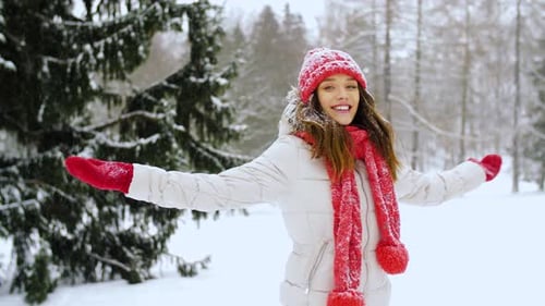 People, Season and Christmas Concept - Happy Young Woman in Winter Forest