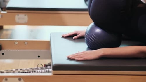 Woman Using Pilates Machine to Exercise