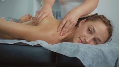 Close Up Masseur Hands Doing Massage with Oil in Beauty Spa Woman Lying Down on Spa Bed