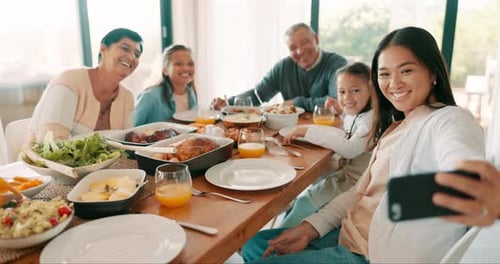 Family Gathering Around Table Smiles For Selfie