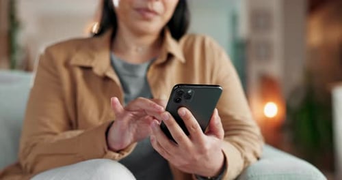 Woman using cellular phone indoors