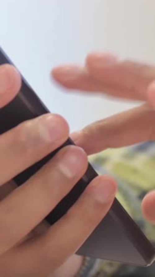 Close up of African Man Using Smartphone for Browsing Internet, Vertical Video