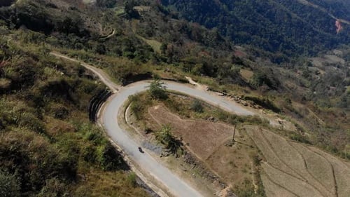 Aerial view of winding road through mountains and valleys, Vietnam.