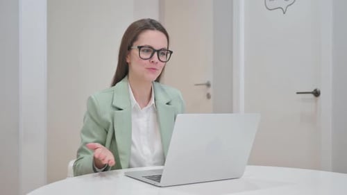 Woman at Computer Having Video Conference at Home