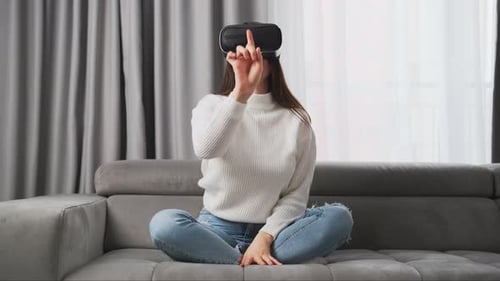 Woman Using Virtual Reality Headset on Couch