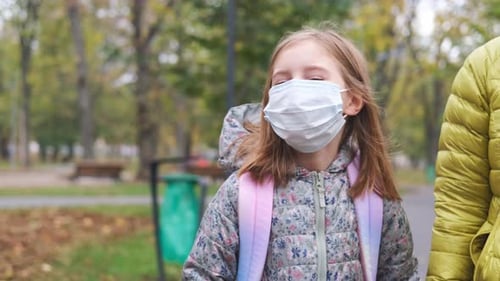 Little Girl in Mask Going to School
