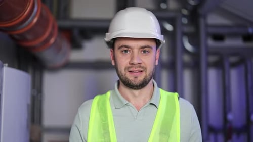 Power Generation Plant Worker Smiles Confidently in Boiler Room
