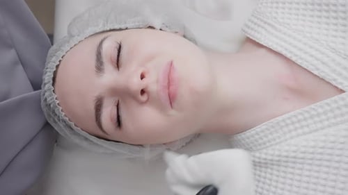 Woman in Spa with Facial Treatment Mask