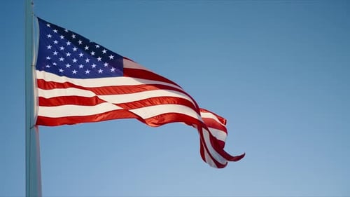 American Flag Waving Proudly in the Blue Sky