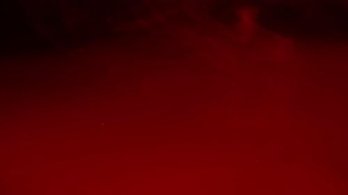 Particules rouges abstraites et fumée