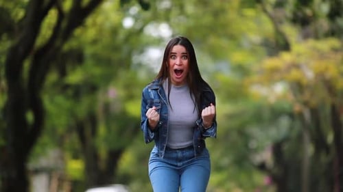 Woman Expressing Shock and then Cheering in Park