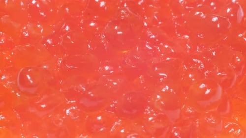 Closeup of Red Salmon Roe Spinning on a Plate