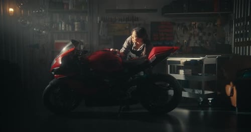 Sun Streams Into Stylish Garage As Biker Woman Tenderly Polishes Motorcycle