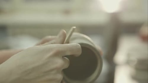 Potter in Workshop Covers the Wax Cup Made of Clay
