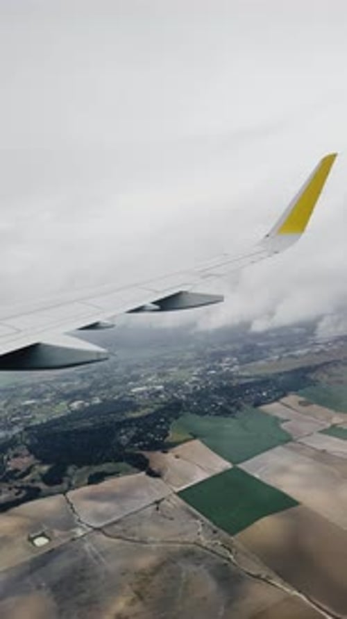 Vertical Screen Aerial View Through Airplane Window in the Morning Travel By Air