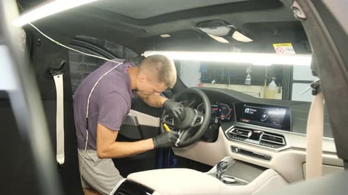 Man Cleaning the Interior of a Car