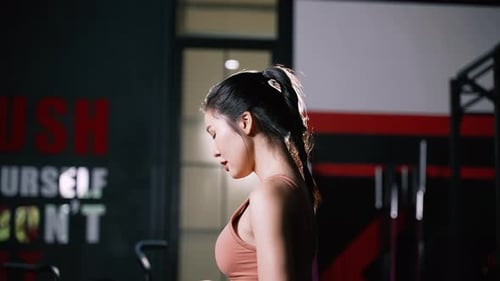 Athlete Asian Woman Drinking Pure Water After Workout Exercise or Training Building Muscles