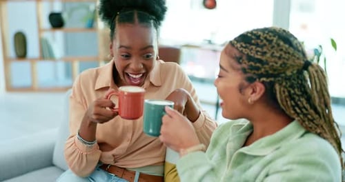 Two Friends Laughing and Talking Indoors