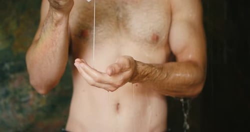 Young Man Takes Shampoo to Wash Properly Hair in Shower