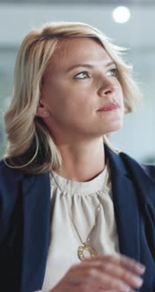Woman Thinking, Looks Upward in Office Setting