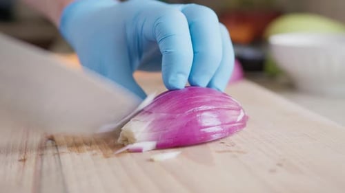 Close Up of Person Dicing a Red Onion