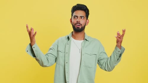 Enthusiastic Man Gesturing on a Yellow Background