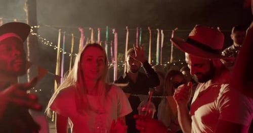 Group of Young Adults Dancing at Outdoor Party