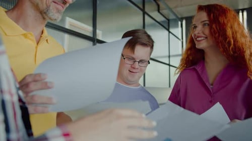 Smiling Team Collaborating on Documents in Urban Office