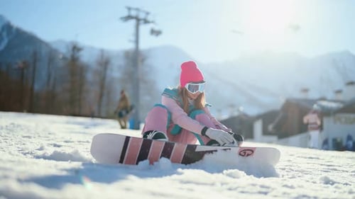 Snowboarder Woman Sets Boots Equipment Snowboarding Tired Girl is Preparing to Go Down Mountain on