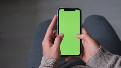 holding green screen phone