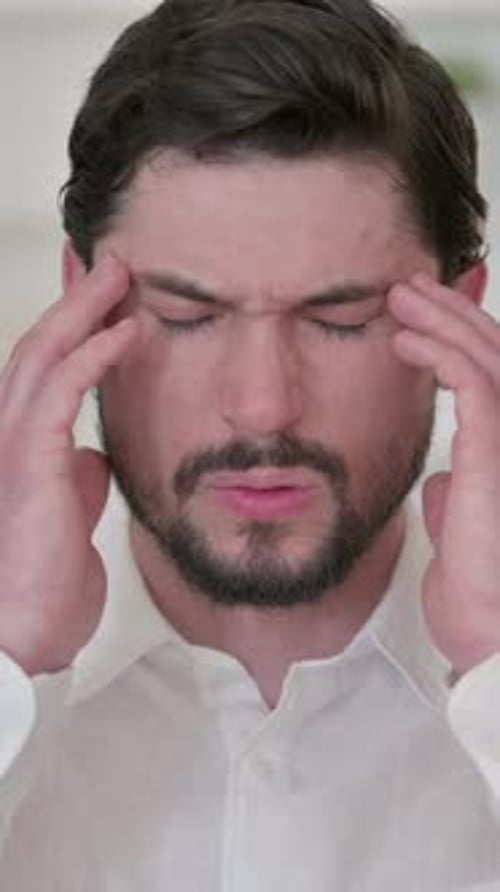 Tired Man having Headache, vertical video