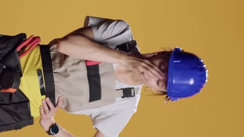 Vertical Video Portrait of Tired Drained Handywoman Yawning After Building Work