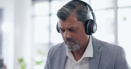 Music, headphones and senior business man in office streaming podcast or radio