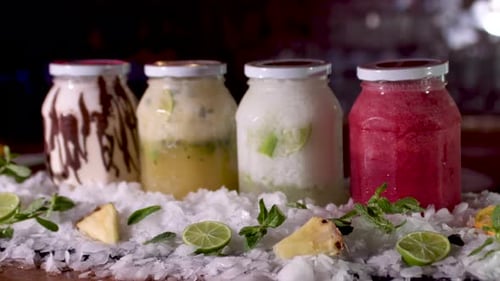 Colourful Frozen Smoothie Jars On Bar. Dolly Forward, Rack Focus Reveal, Track forward